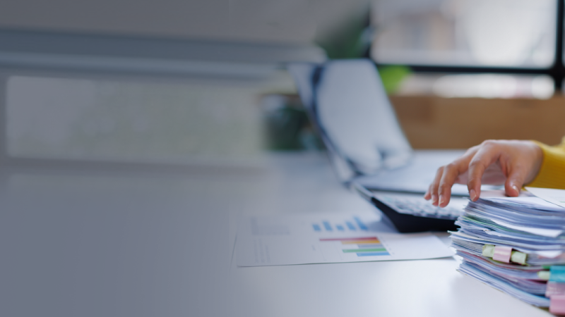 Worker organizing a large stack of documents 