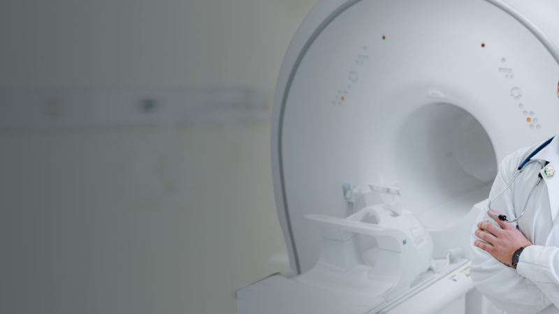 Physician working with MRI machine