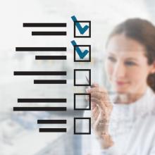 hospital worker checks boxes demonstrating safety compliance after initial equipment installation following acceptance testing