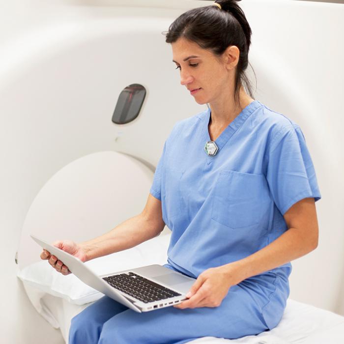 ct tech accessing landauer academy online radiation safety training classes for asrt and ce credits on laptop computer