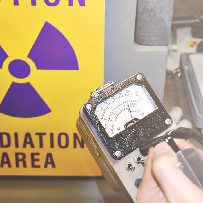 medical physicist conducting radiation survey illustrating nuclear medicine equipment and regulatory support from landauer