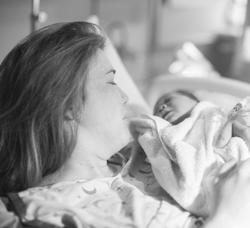 Mother and newborn baby shown in a medical setting where fetal radiation badges monitor pregnant workers